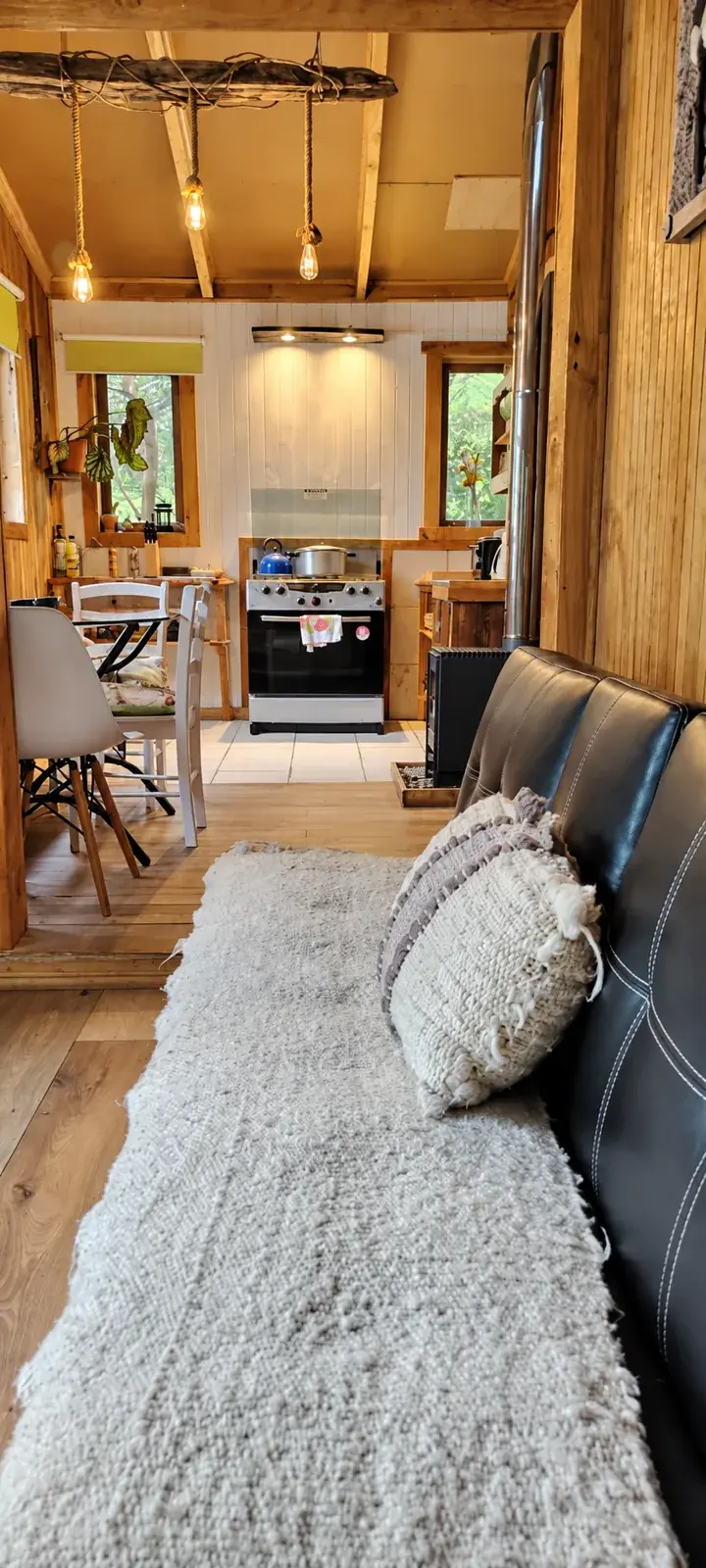 Interior de Tejuela con living, comedor y cocina al fondo